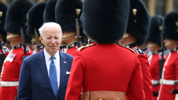 US President Joe Biden inspects the Guard of Honour from the Prince of Wales's Company of the Welsh Guards, in the quadrangle,  during his visit to Windsor Castle, in Windsor, England, Monday, July 10, 2023. (Ian Vogler/Pool Photo via AP)