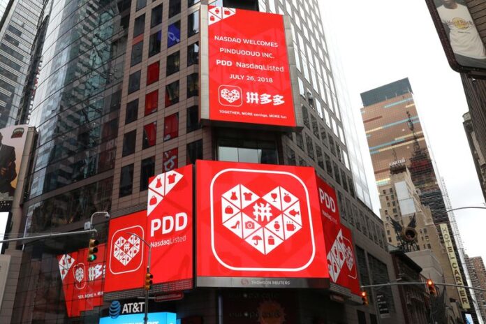 FILE PHOTO: A display at the Thomson Reuters building shows a message after Chinese online group discounter Pinduoduo Inc. (PDD) was listed on the Nasdaq exchange in Times Square in New York City