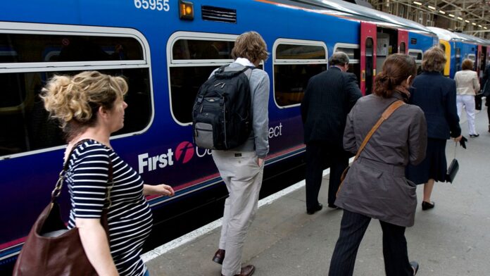 Commuters on a First Capital Connect Service at King's Cross Station, London. (Newscast Limited via AP Images)