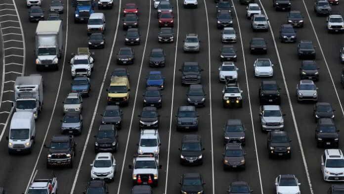 Heavy traffic fills multiple lanes of the San Francisco–Oakland Bay Bridge as cars and trucks travel during a busy holiday weekend.