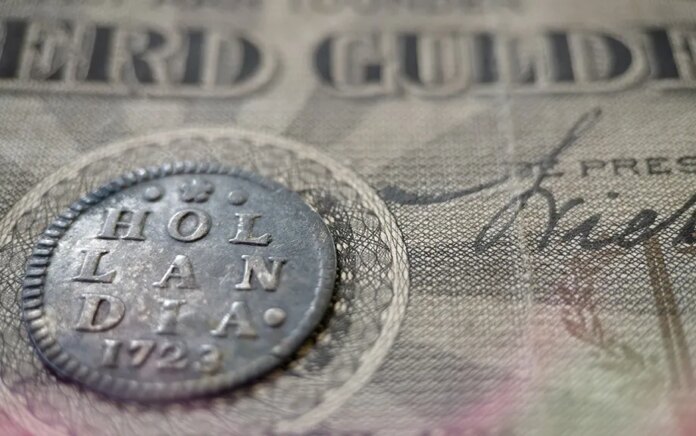 Photo: Old Dutch coins from the province of Holland with ancient Dutch banknotes.