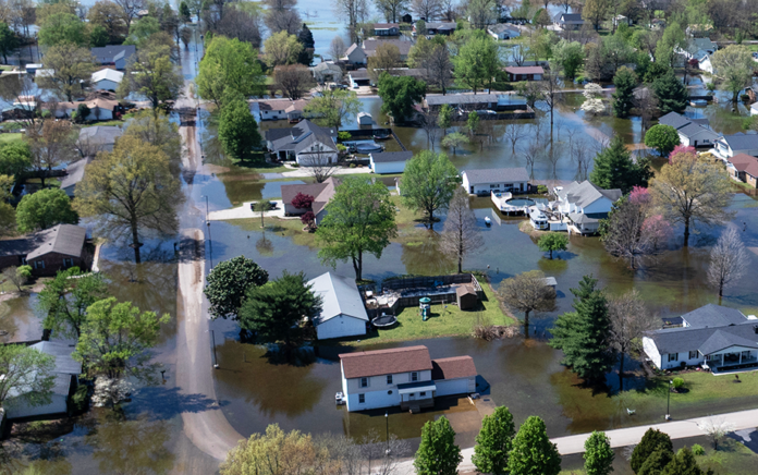 An aerial view shows floodwater surrounding homes on April 07, 2025 in East Prairie, Missouri. Thunderstorms, heavy rains, high winds and tornadoes have plagued the region for the past several days, causing widespread damage before moving east. (Photo by Scott Olson/Getty Images)