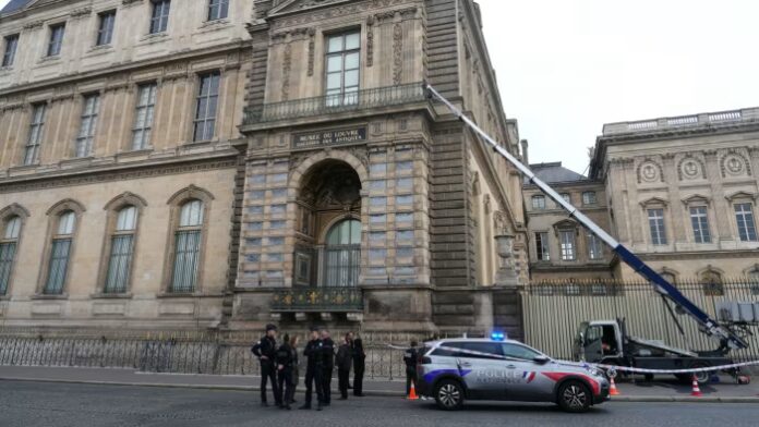 Police officers outside the Louvre on Sunday