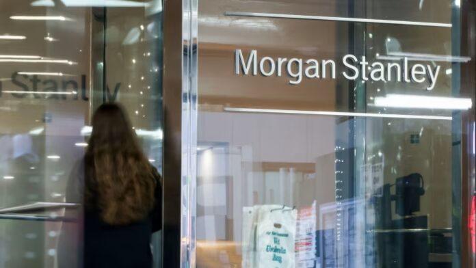 A person enters the Morgan Stanley headquarters through glass doors, with the company name displayed on a glass wall.